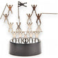 Mellow Monkey magnetic desktop sculpture featuring stainless steel acrobat figures arranged on a black circular base.