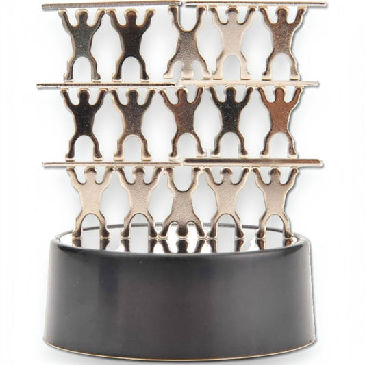 Mellow Monkey magnetic desktop sculpture featuring stainless steel acrobat figures stacked on a black base.