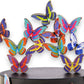 Mellow Monkey magnetic desktop sculpture featuring colorful stainless steel butterfly pieces on a black base.
