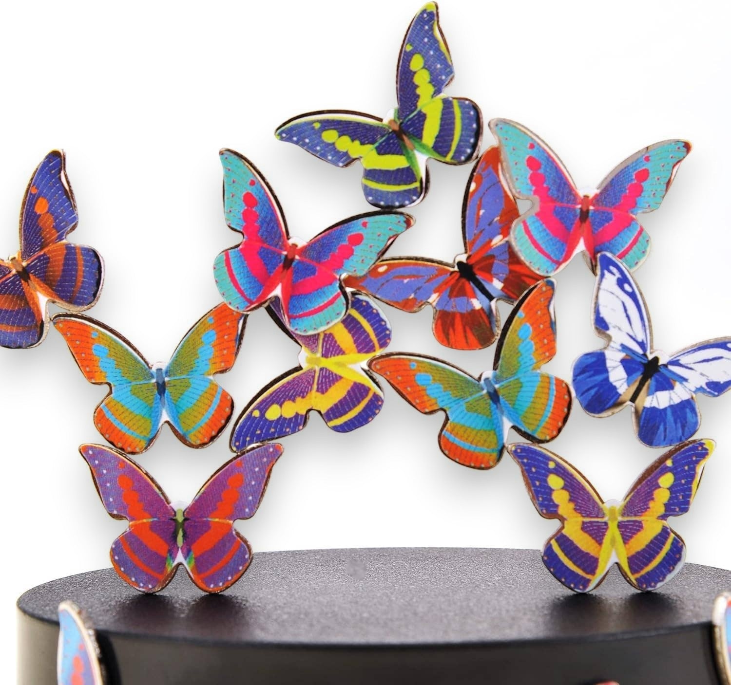 Mellow Monkey magnetic desktop sculpture featuring colorful stainless steel butterfly pieces on a black base.