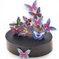 Mellow Monkey magnetic desktop sculpture featuring colorful stainless steel butterfly pieces on a black base.