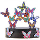 Mellow Monkey magnetic desktop sculpture featuring colorful butterfly-shaped stainless steel pieces on a black base.