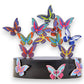 Mellow Monkey magnetic desktop sculpture featuring colorful butterfly-shaped stainless steel pieces on a black base.
