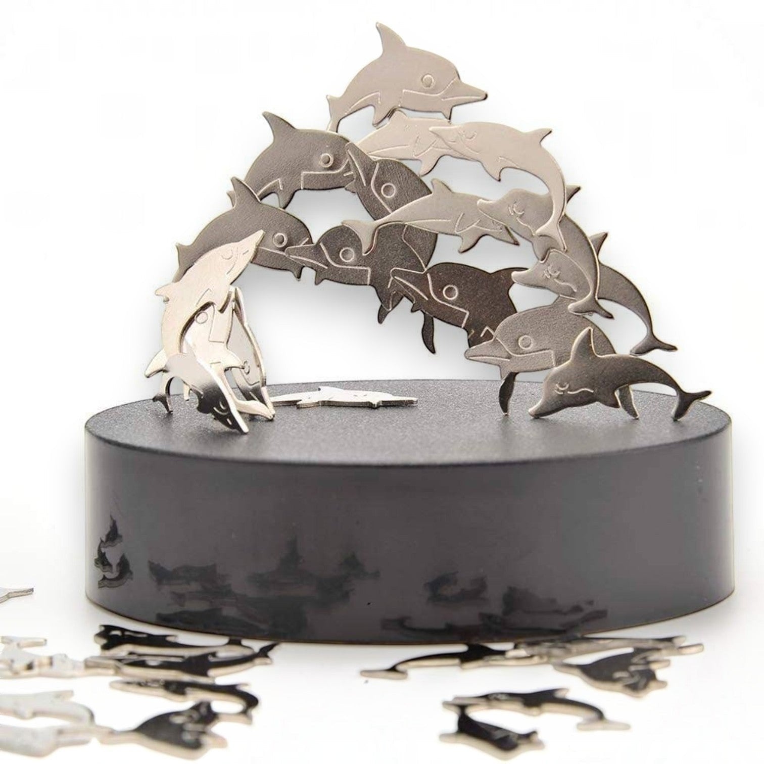 Mellow Monkey magnetic dolphin desktop sculpture with polished stainless steel figures on a black circular base.