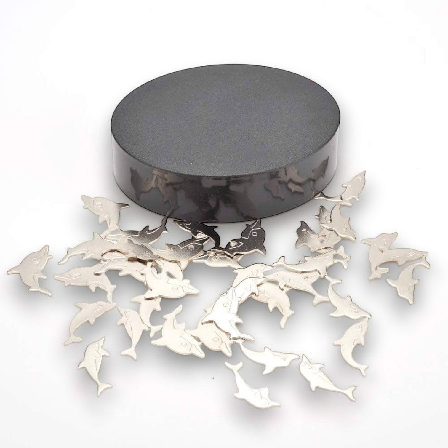 Mellow Monkey magnetic desktop sculpture featuring polished stainless steel dolphin figures on a black magnetic base.