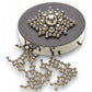 Mellow Monkey magnetic sculpture desk toy with stainless steel balls arranged on a circular black magnetic base.