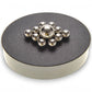 Mellow Monkey magnetic sculpture desk toy with silver stainless steel balls arranged on a round black magnetic base.