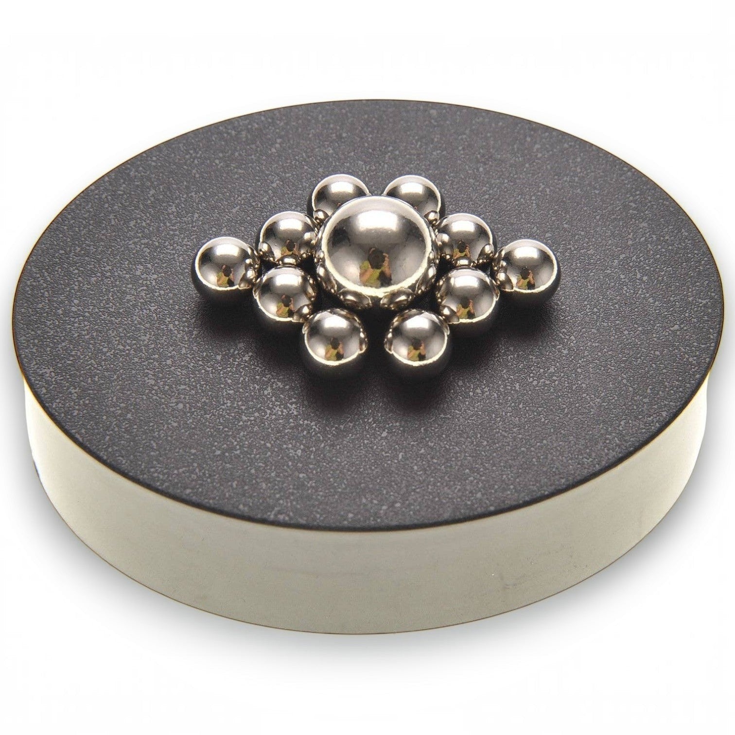 Mellow Monkey magnetic sculpture desk toy with silver stainless steel balls arranged on a round black magnetic base.