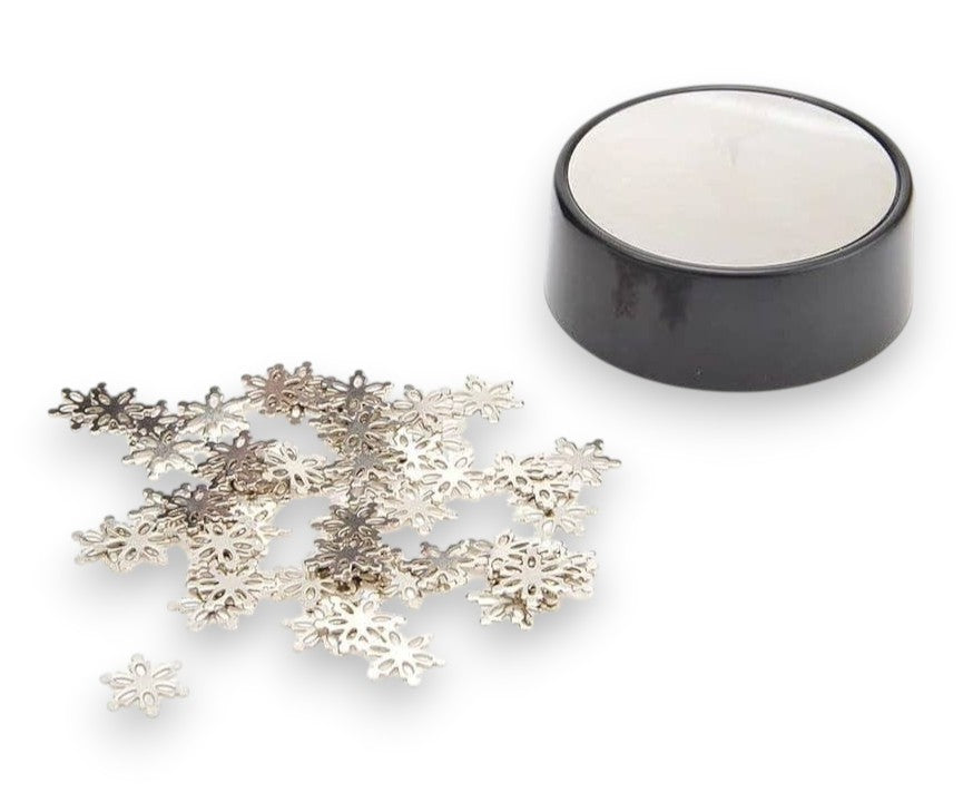 Mellow Monkey magnetic desktop sculpture set featuring small stainless steel snowflake pieces and a black base.