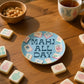 Mellow Monkey ceramic Mahjong trinket tray with gold foil rim and Mahj All Day text on a wooden table with tiles.