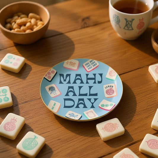 Mellow Monkey ceramic Mahjong trinket tray with gold foil rim and Mahj All Day text on a wooden table with tiles.
