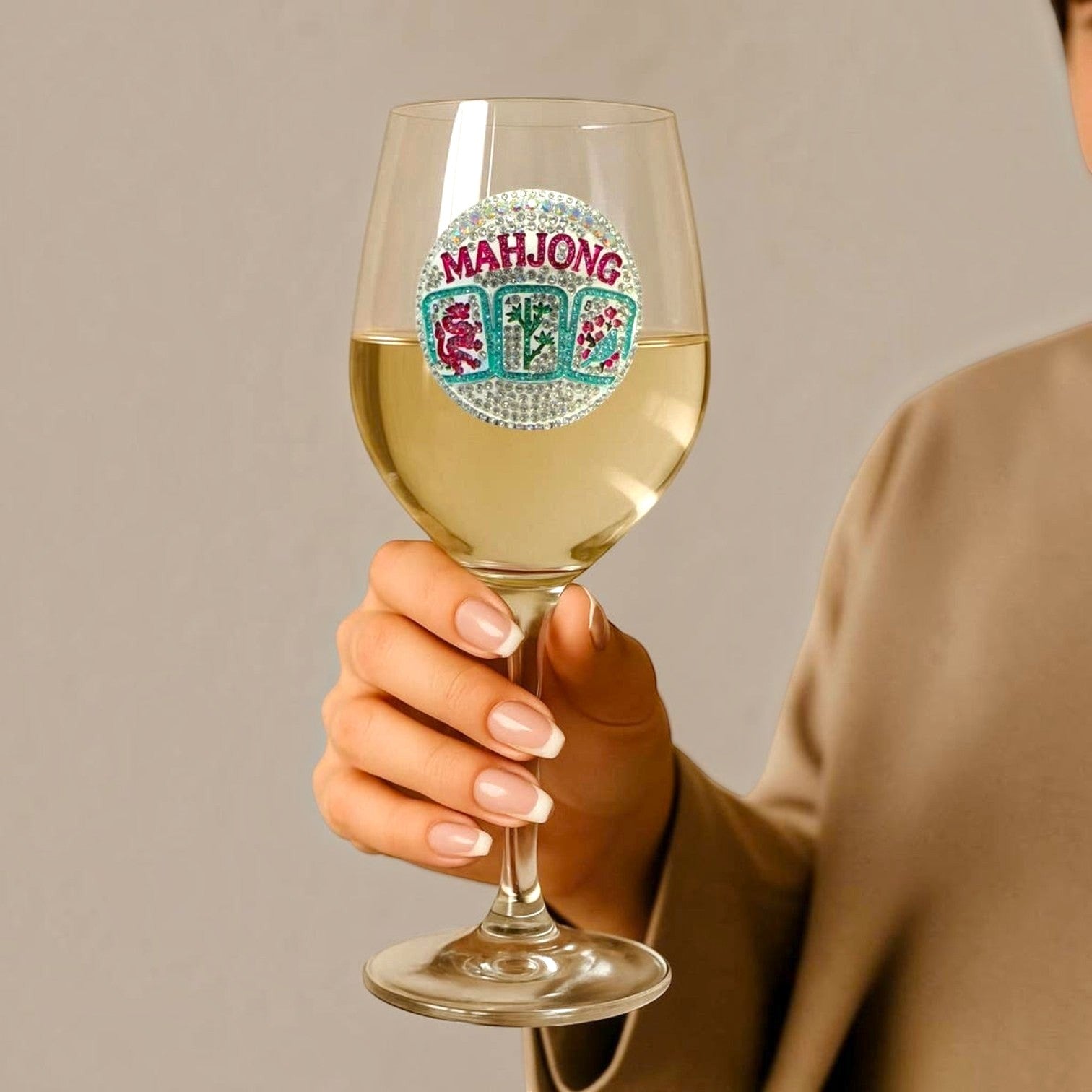 Mellow Monkey 19 oz stemmed wine glass featuring a handcrafted jeweled Mahjong tile design held by a woman