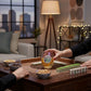 Mellow Monkey stemless wine glass with Mahjong tile design held by a person at a game table with snacks