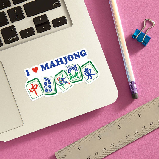 Mellow Monkey I Heart Mahjong die cut vinyl sticker on a laptop, featuring mahjong tiles and a red heart icon.