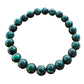 Mellow Monkey 8mm green malachite synthetic stone bead bracelet on a wooden surface