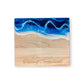 Mellow Monkey maple wood cheese board featuring a blue resin ocean wave design and Taste of Connecticut engraving.