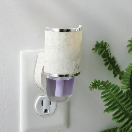 Mellow Monkey Marble WallScents fragrance warmer plugged into a wall outlet with a purple oil refill.