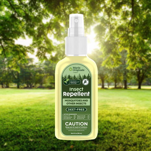 Mellow Monkey Marie Originals plant-based DEET-free insect repellent spray bottle in a sunny outdoor forest setting.