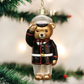 Mellow Monkey Marine Bear blown glass ornament wearing a dress blue uniform and saluting, hanging on a Christmas tree.