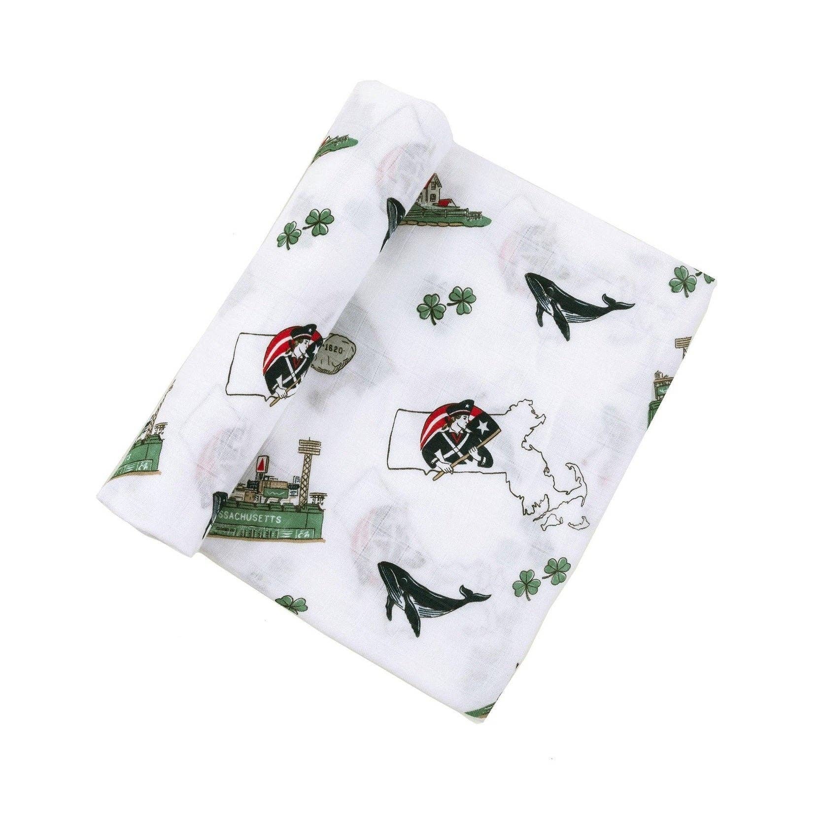 Mellow Monkey Massachusetts themed muslin baby swaddle blanket with state icons, whales, and clovers on white fabric.
