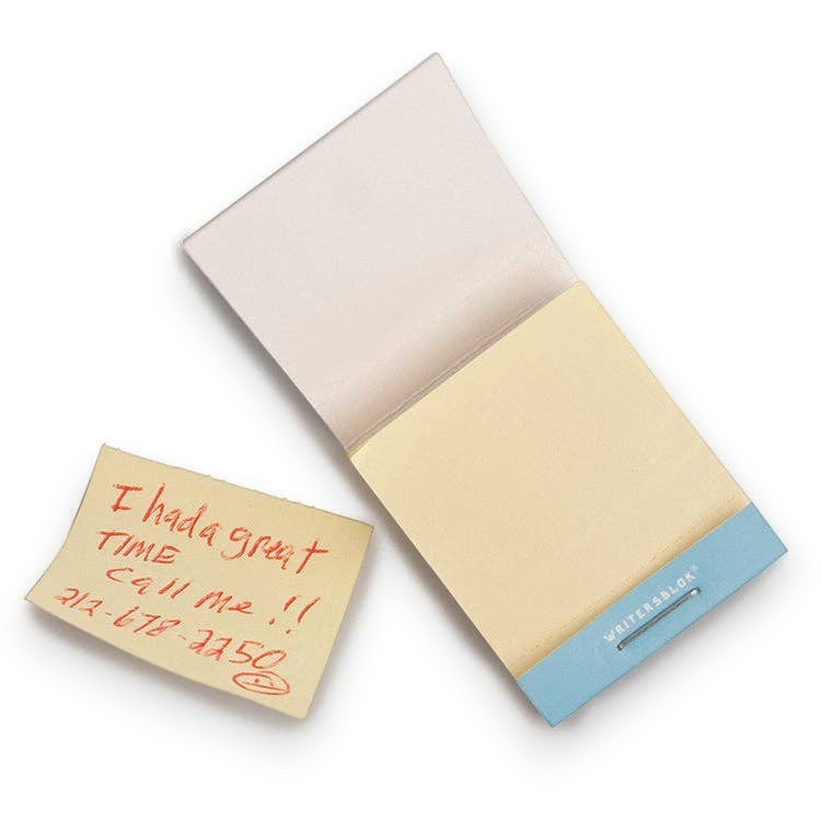 Mellow Monkey matchbook style sticky note pad with a light blue cover and a handwritten note on a yellow adhesive slip