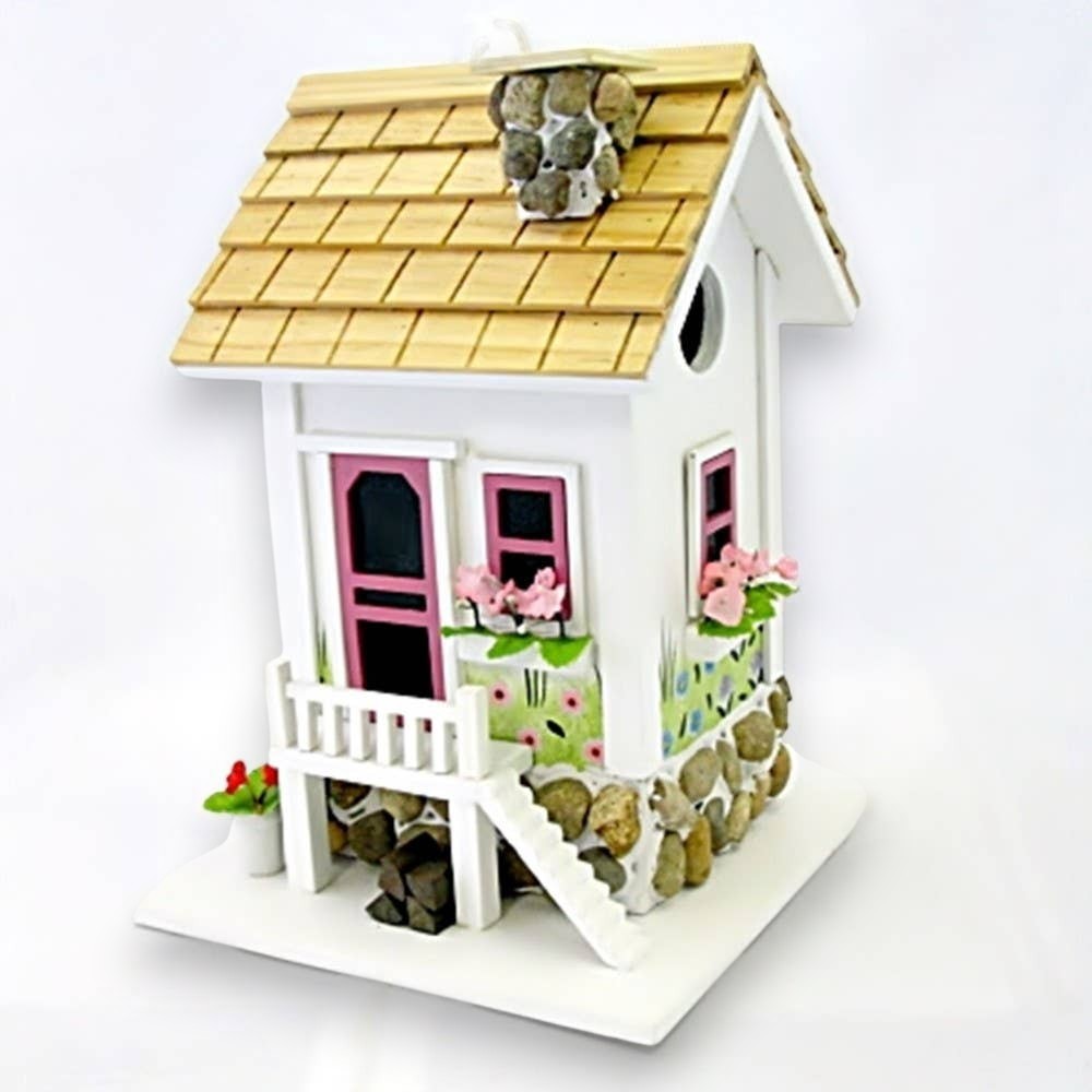 Mellow Monkey May Cottage birdhouse with white exterior, pink door and windows, stone accents, and floral details.