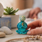 Mellow Monkey meditating turtle figurine with a vibrant blue finish, perfect for a zen home decor accent.