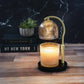 Mellow Monkey mercury glass candle warmer lamp with gold shade, adjustable stem, and black base on a wooden table.