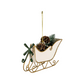 Mellow Monkey white iron sleigh Christmas ornament with bottle brush tree, pinecones, and a festive green bow.