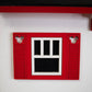 Mellow Monkey Mickey Cottage birdhouse, red with white trim and black window panes. Features Mickey ears cutouts.