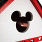 Mellow Monkey Mickey Cottage birdhouse, white with red trim and Mickey Mouse shaped entrance hole. Features cleanout, drainage, and ventilation.