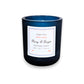 Mellow Monkey Merry & Bright scented candle in a deep midnight blue glass vessel with apple, spice, and oak notes.