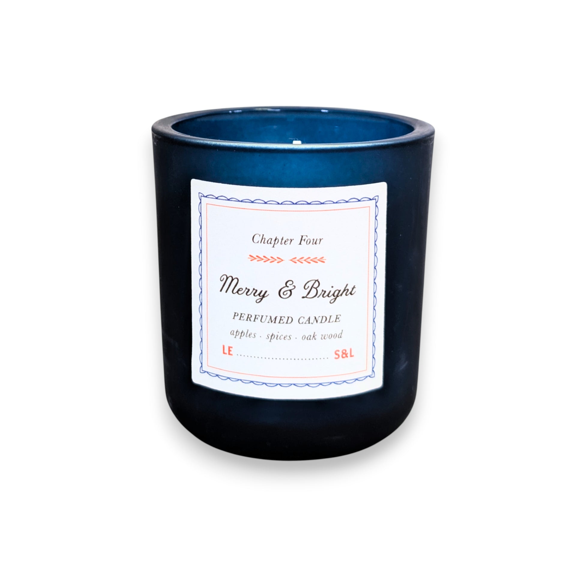 Mellow Monkey Merry & Bright scented candle in a deep midnight blue glass vessel with apple, spice, and oak notes.