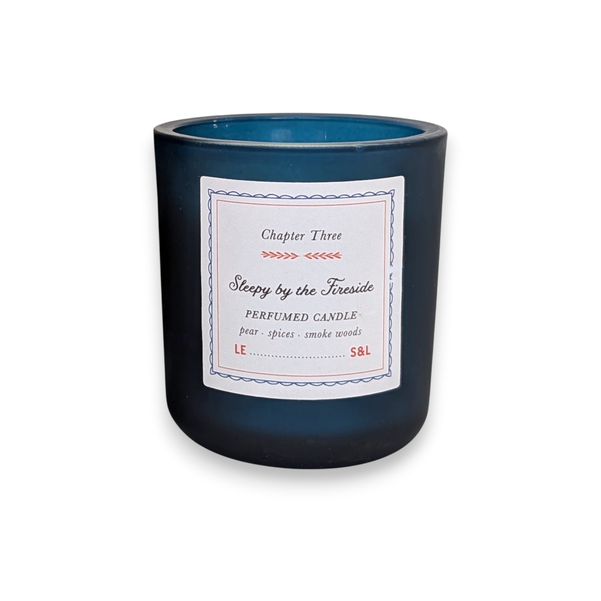 Mellow Monkey Sleepy by the Fireside scented candle in a deep midnight blue glass vessel with a storybook label.