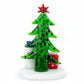 Mellow Monkey Milano Art Glass Christmas tree figurine with a red star, snowman, and gift on a white base.