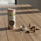Mellow Monkey mimosa and cardamom incense cones with a small round ceramic holder on a wooden table.