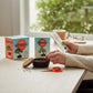 Mellow Monkey Mini Bonsai Tree Kit with seeds, pot, scissors, and guide on a wooden desk