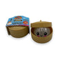 Mellow Monkey Mini Mystery Dumpling squishy toy in a plastic steamer basket with glittery finish and cute face.