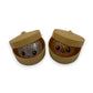 Mellow Monkey Mini Mystery Dumpling squishy toys with glittery silver and gold faces in bamboo steamer containers.