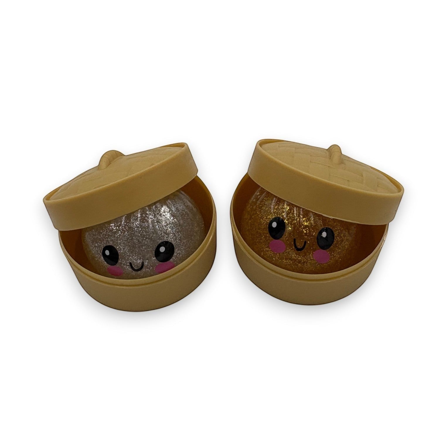Mellow Monkey Mini Mystery Dumpling squishy toys with glittery silver and gold faces in bamboo steamer containers.