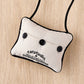 Mellow Monkey University of Connecticut mini pillow ornament with black buttons and hanging cord on wood background