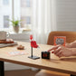 Mellow Monkey Take A Number! mini ticket dispenser with digital display and paper tickets on an office desk