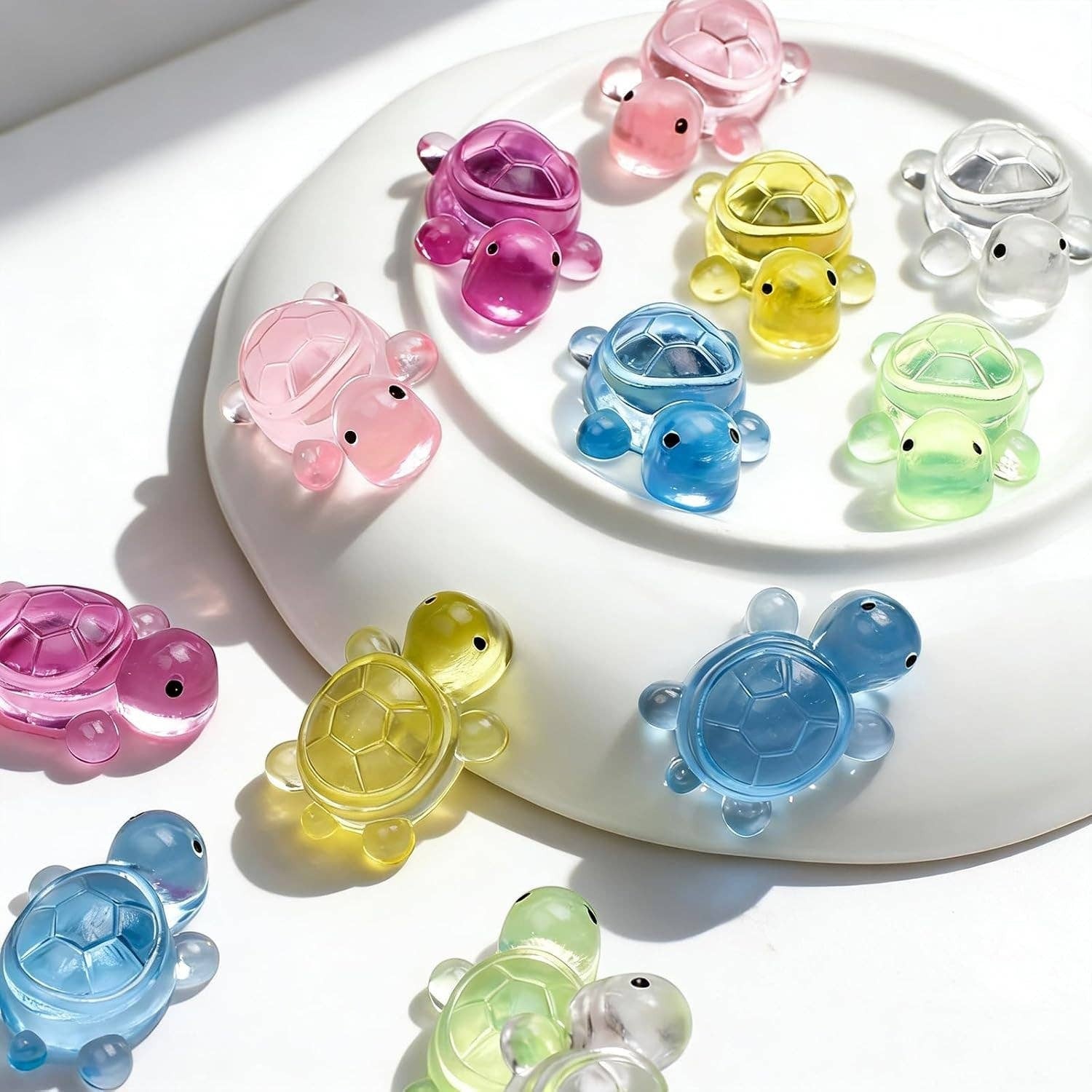 Mellow Monkey 12-pack of miniature jelly-soft squishy turtles in assorted translucent colors on a white plate.