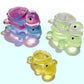 Mellow Monkey miniature squishy turtles in translucent pink, blue, green, and yellow jelly-like material