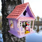 Mellow Monkey Minnie Icon Pink Birdhouse with Minnie Mouse figure on porch. Purple house with pink roof, windows, and trim.