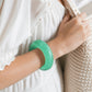 Mellow Monkey FEELZiES Jelly Donut Squishy wearable sensory fidget bracelet in mint green worn on a woman's wrist.