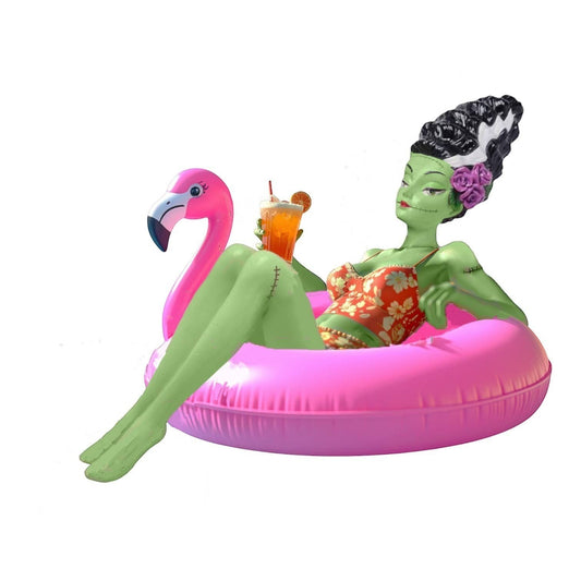 Mellow Monkey December Diamonds Monster Bride figure relaxing on a pink flamingo float with a cocktail. Green skin, floral swimsuit, stitched details.