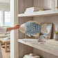 Mellow Monkey mosaic capiz and metal fish sculpture with blue tiles on a whitewashed wooden base displayed on a shelf.