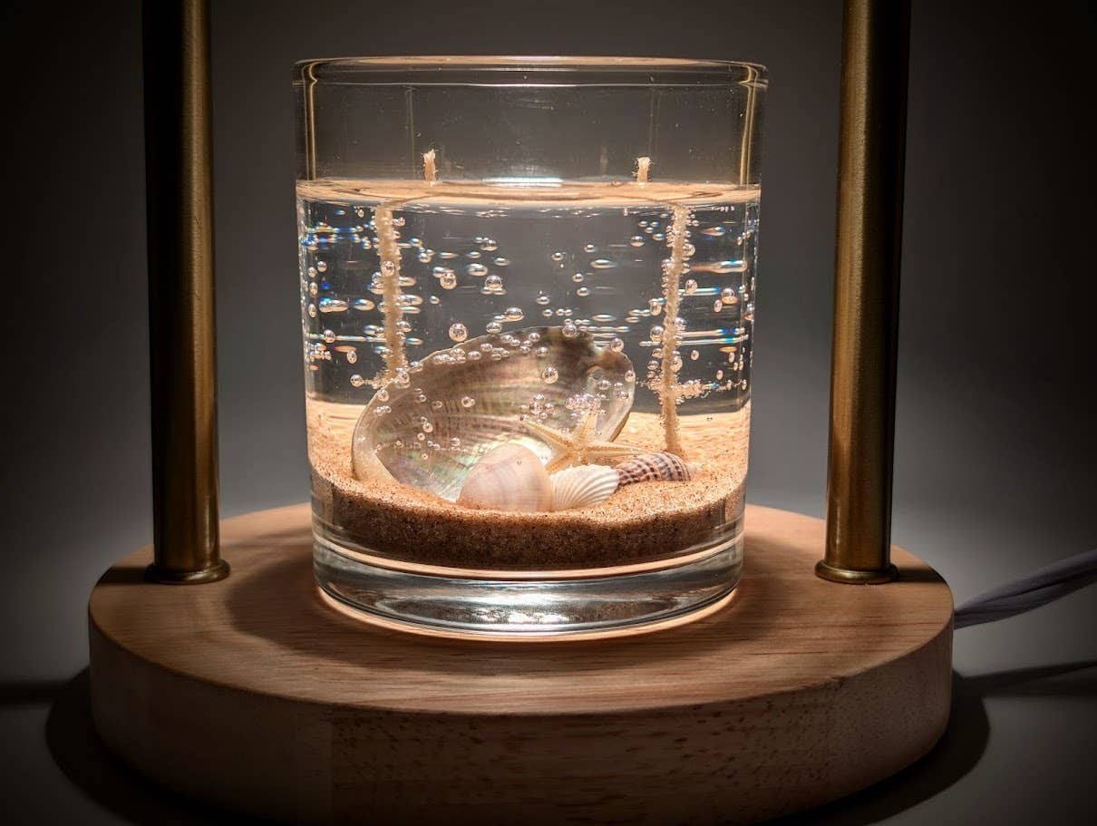 Mellow Monkey 8-oz double wick gel candle featuring a mother of pearl shell and sand in a clear glass jar.