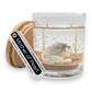 Mellow Monkey Mother of Pearl double wick gel candle with seashells and sand in a glass jar with a wooden lid.